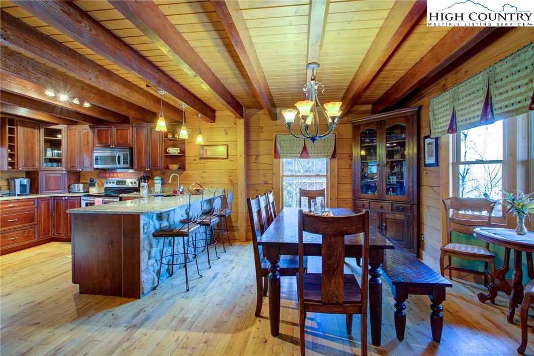 186 Riversound Drive Banner Elk, NC 28604 - Photo 19 of 45 a view of a dining room with furniture window and wooden floor
