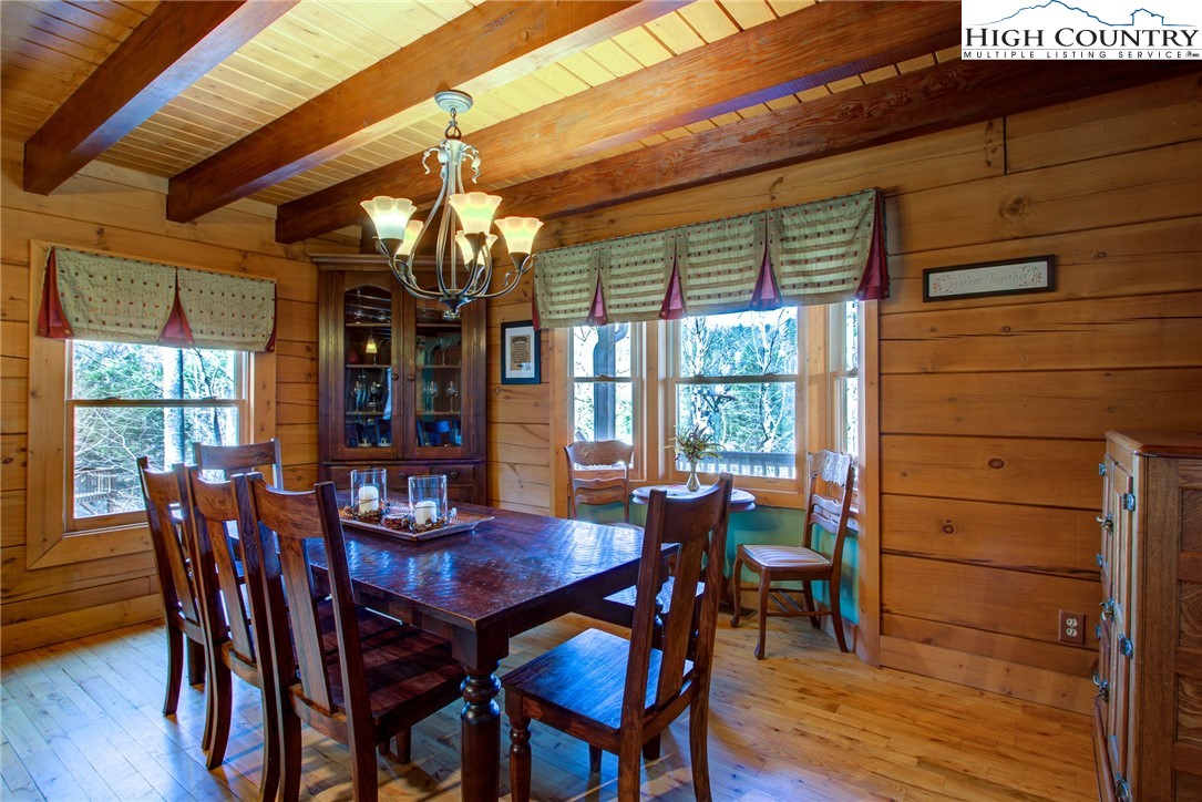 186 Riversound Drive Banner Elk, NC 28604 - Photo 20 of 45 a view of a dining room with furniture window and wooden floor