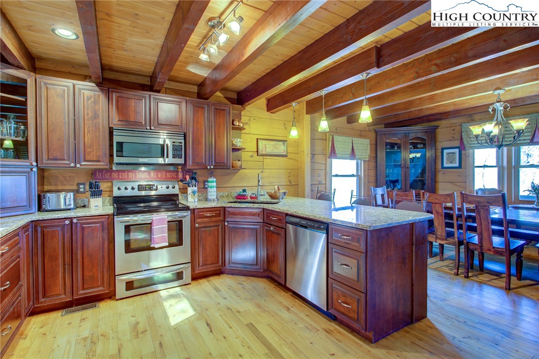 186 Riversound Drive Banner Elk, NC 28604 - Photo 23 of 45 a kitchen with stainless steel appliances granite countertop wooden cabinets a sink and dishwasher