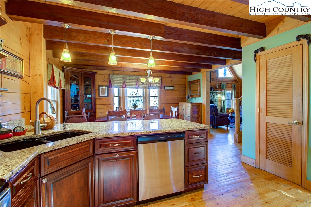 186 Riversound Drive Banner Elk, NC 28604 - Photo 24 of 45 a kitchen with stainless steel appliances granite countertop a sink and wooden cabinets