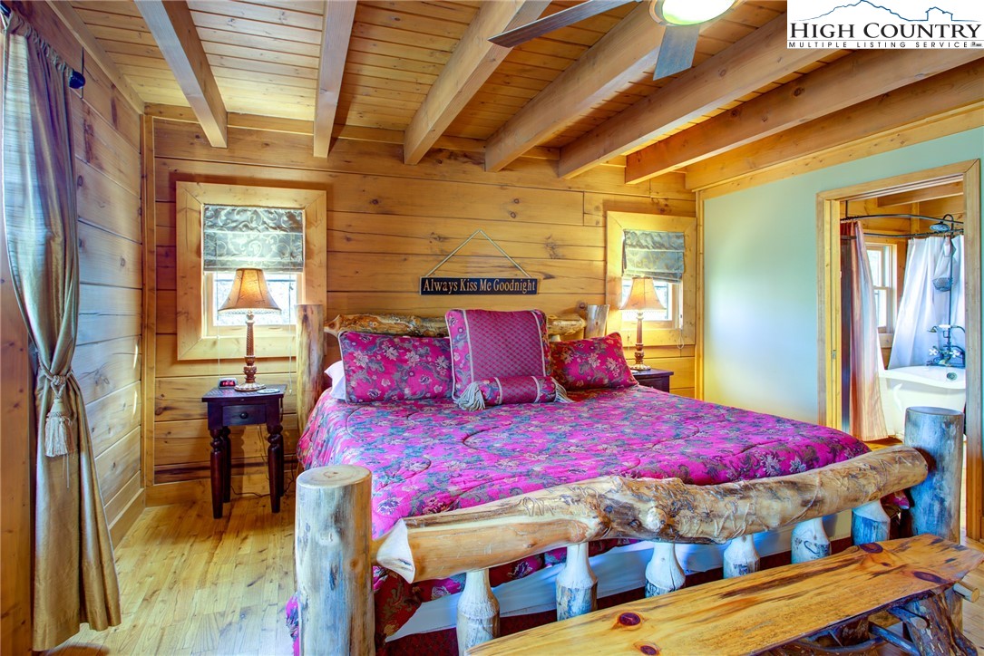 186 Riversound Drive Banner Elk, NC 28604 - Photo 29 of 45 a bedroom with a bed and wooden floor