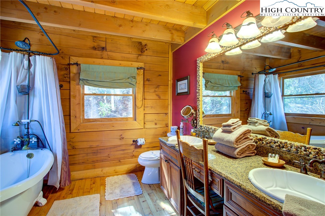 186 Riversound Drive Banner Elk, NC 28604 - Photo 31 of 45 a bathroom with a granite countertop tub sink and mirror