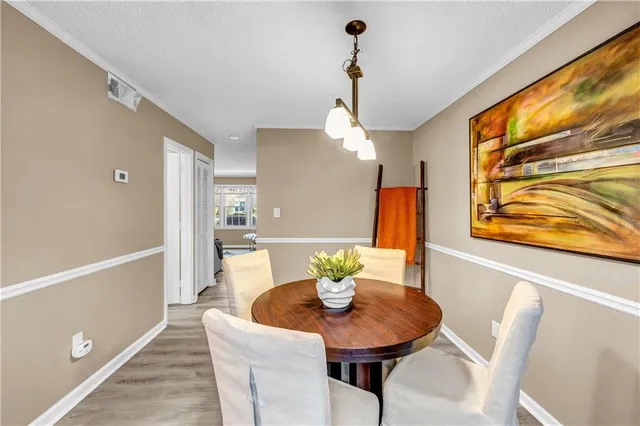 a view of a dining room with furniture and a chandelier