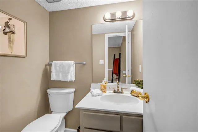 a bathroom with a sink toilet and mirror