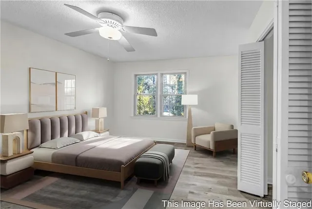 a bedroom with a bed couch and a window