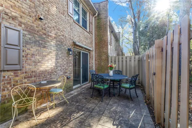a view of a patio with a table and chairs