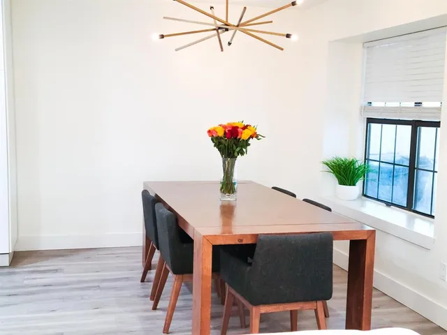 a table with chairs and wooden floor