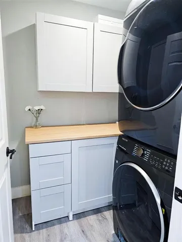 a kitchen with a sink and wooden floor