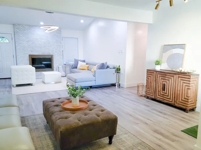 a living room with furniture and a fireplace
