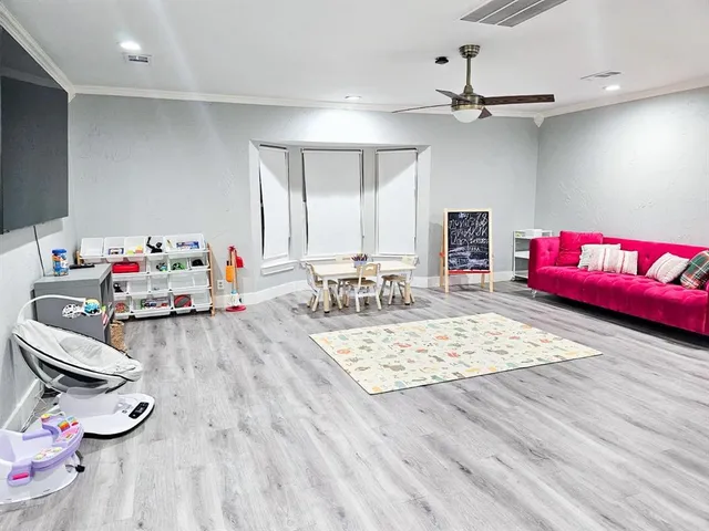 a bedroom with furniture and a wooden floor