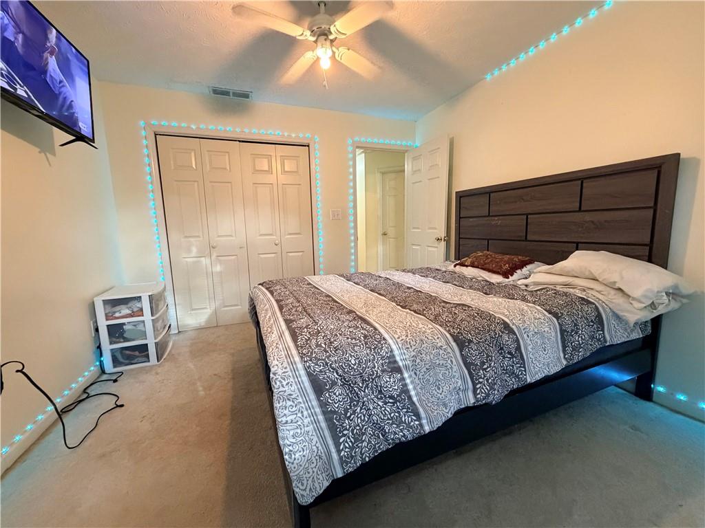 426 Pates Lake Court Hampton, GA 30228 - Photo 19 of 60 a bedroom with a bed painting on wall and a large window