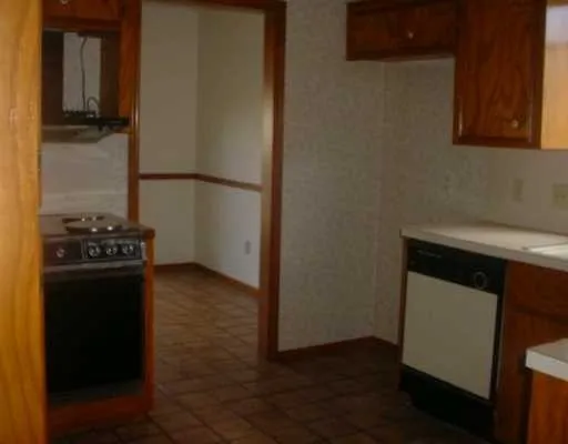 a kitchen with a refrigerator and a stove