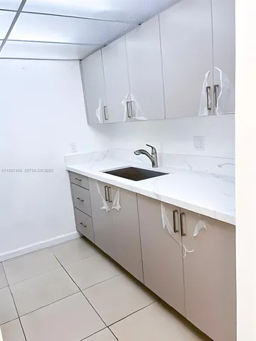 a kitchen with a sink and cabinets