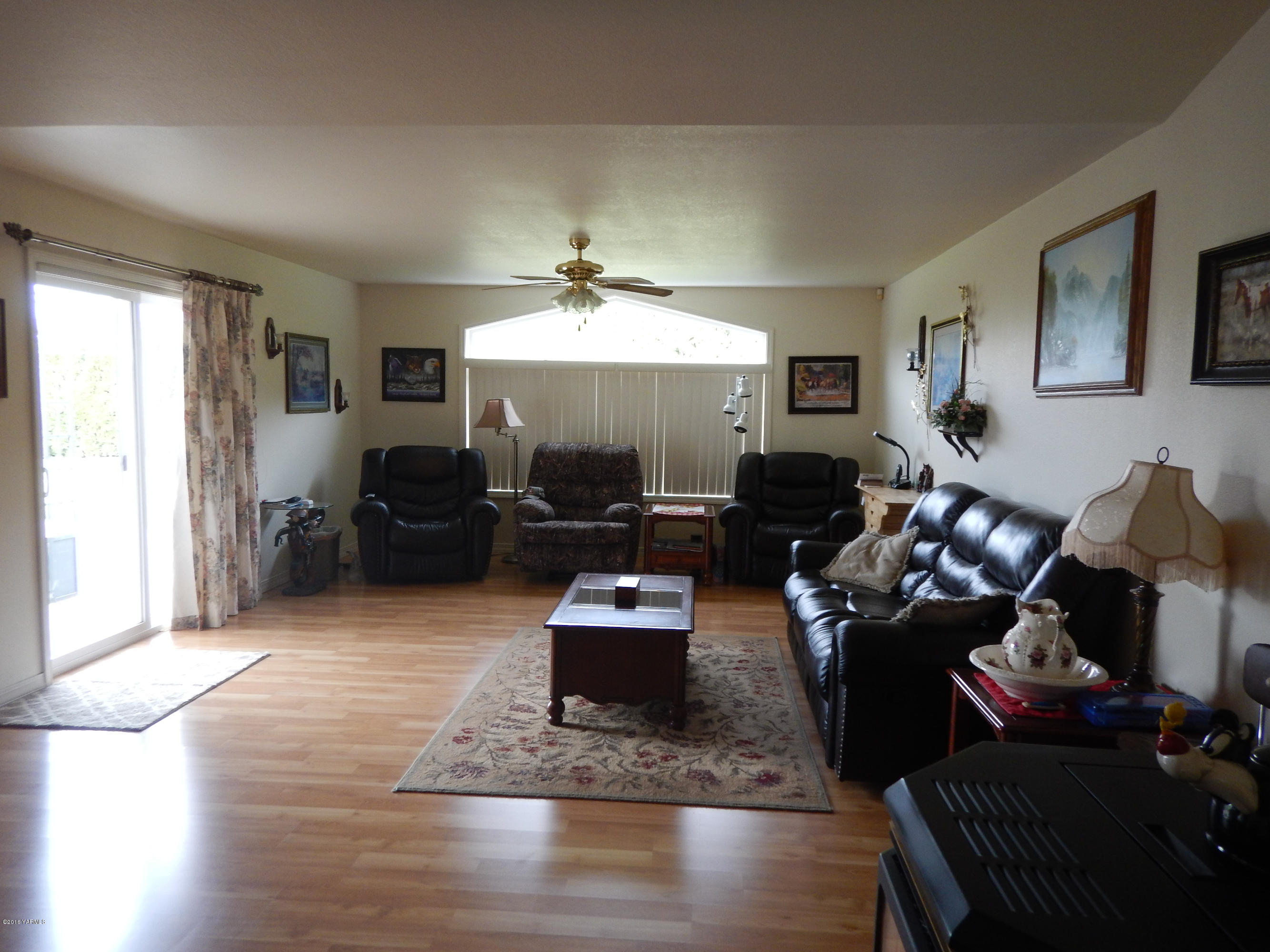 4911 Mieras Road Yakima, WA 98901 - Photo 40 of 58 a living room with furniture and a chandelier