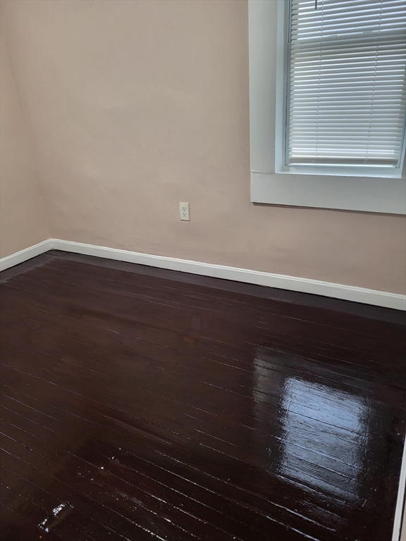 89 Oak Street Fall River, MA 02720 - Photo 14 of 39 a view of a livingroom with wooden floor and a window