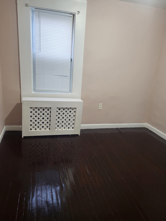 89 Oak Street Fall River, MA 02720 - Photo 15 of 39 an empty room with wooden floor