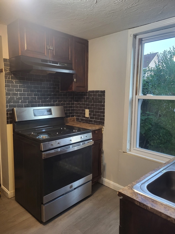 89 Oak Street Fall River, MA 02720 - Photo 6 of 39 a stove top oven sitting inside of a kitchen