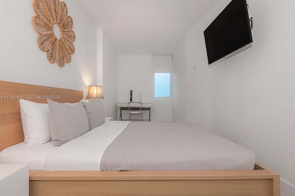 2301 Collins Avenue, Unit 927 Miami Beach, FL 33139 - Photo 1 of 30 a bedroom with a bed and a flat screen tv