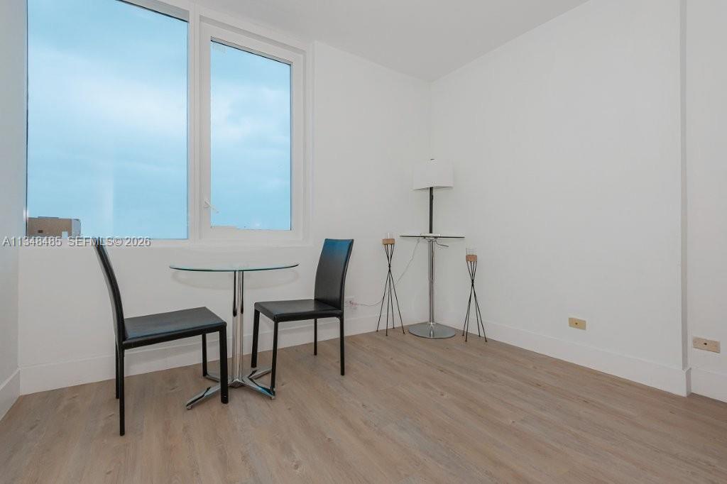 2301 Collins Avenue, Unit 927 Miami Beach, FL 33139 - Photo 12 of 30 a view of a room with furniture and wooden floor