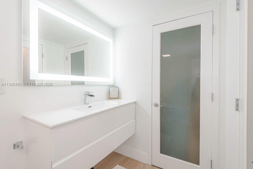 2301 Collins Avenue, Unit 927 Miami Beach, FL 33139 - Photo 15 of 30 a bathroom with a sink and a mirror