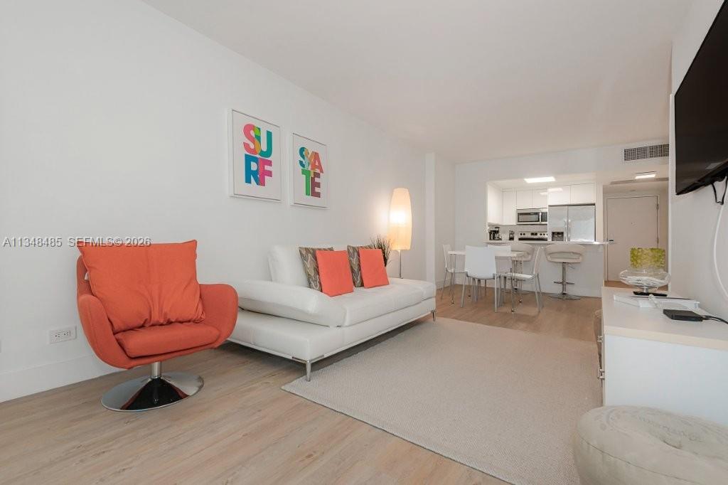 2301 Collins Avenue, Unit 927 Miami Beach, FL 33139 - Photo 16 of 30 a living room with furniture and a flat screen tv