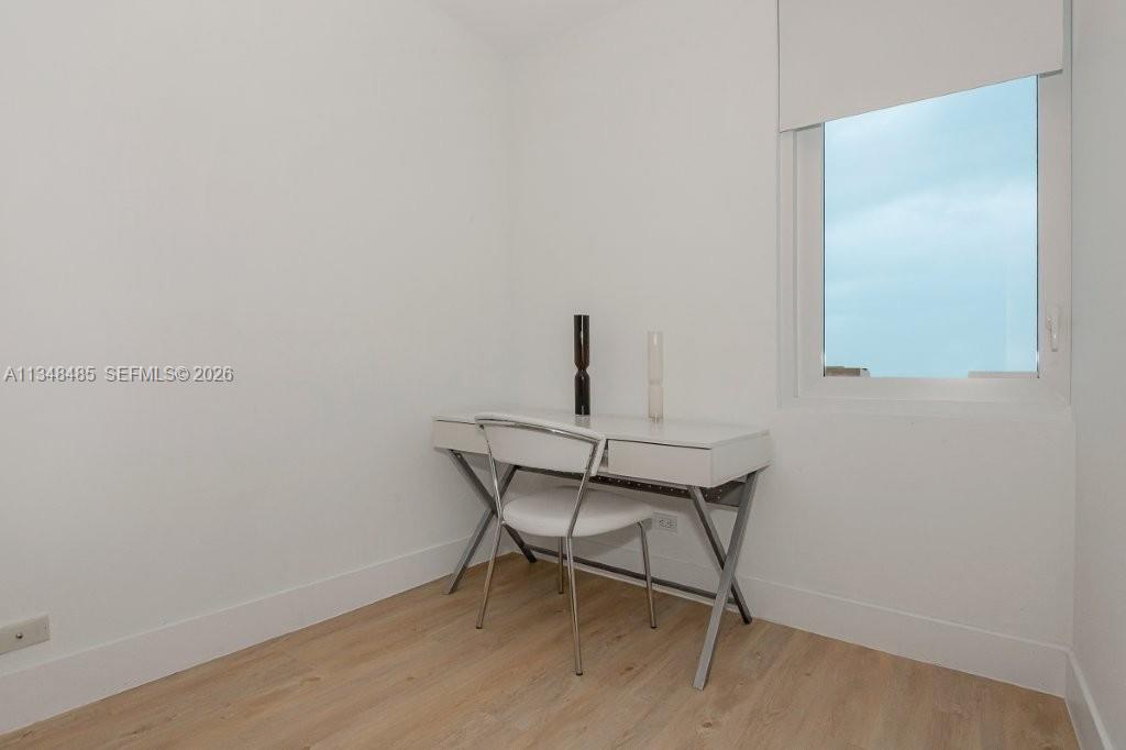 2301 Collins Avenue, Unit 927 Miami Beach, FL 33139 - Photo 20 of 30 a chair and a table in a room