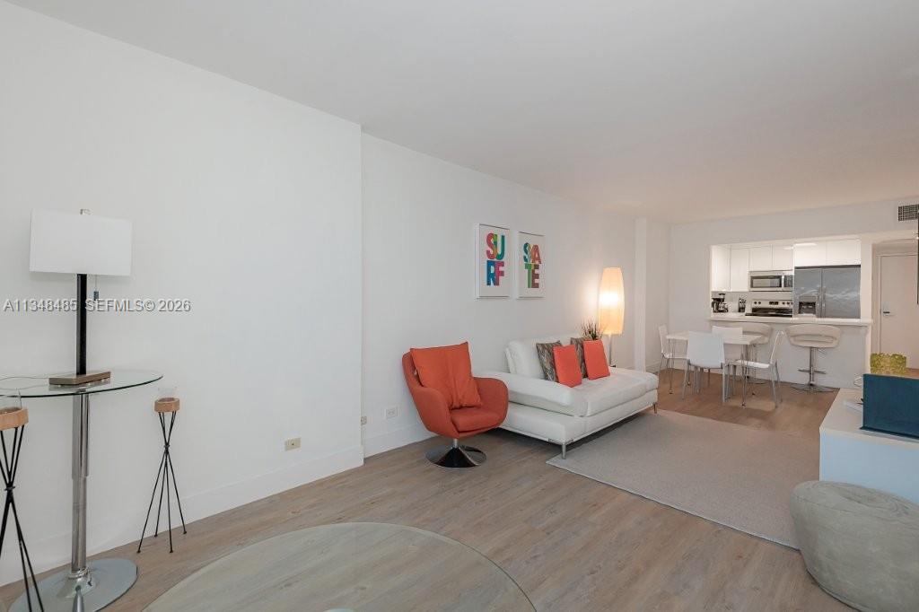2301 Collins Avenue, Unit 927 Miami Beach, FL 33139 - Photo 22 of 30 a living room with furniture and kitchen view