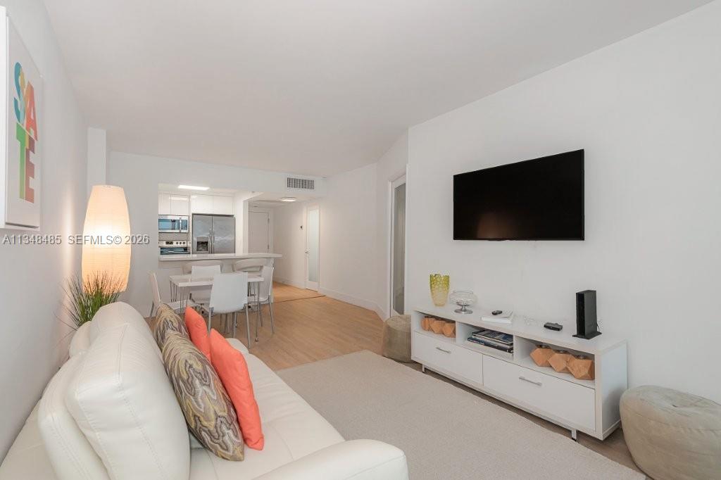 2301 Collins Avenue, Unit 927 Miami Beach, FL 33139 - Photo 3 of 30 a living room with furniture and a flat screen tv