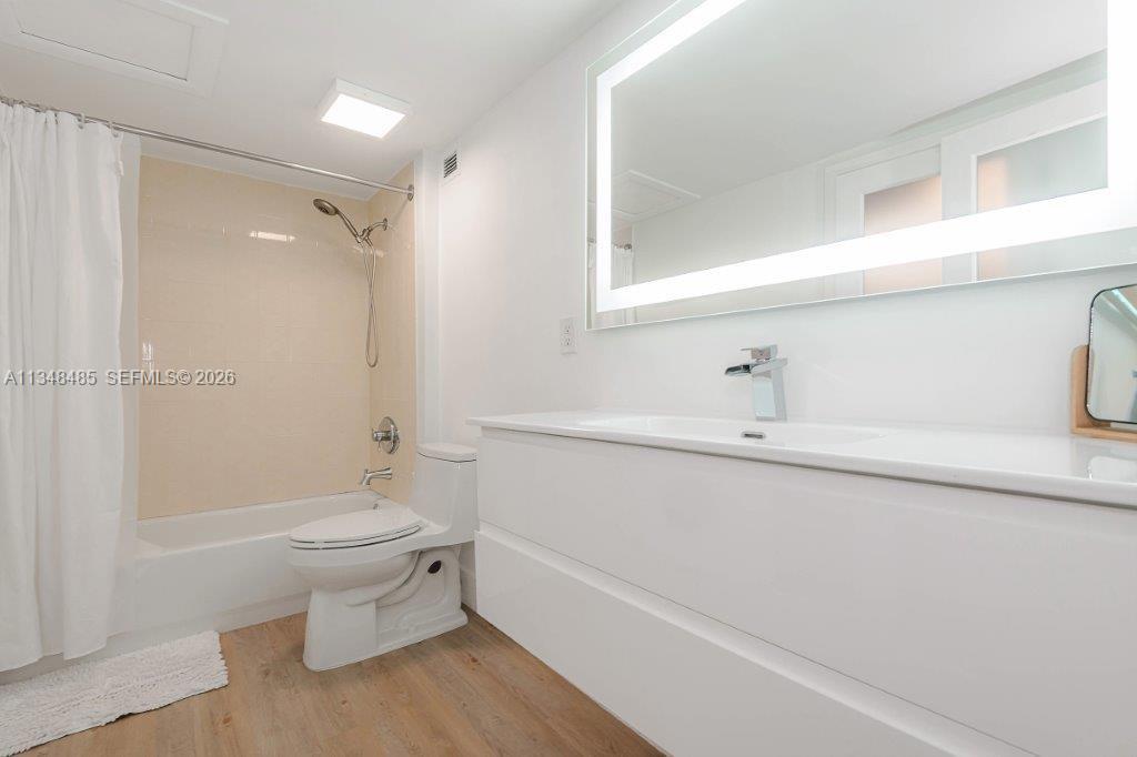 2301 Collins Avenue, Unit 927 Miami Beach, FL 33139 - Photo 8 of 30 a bathroom with a sink a toilet and shower