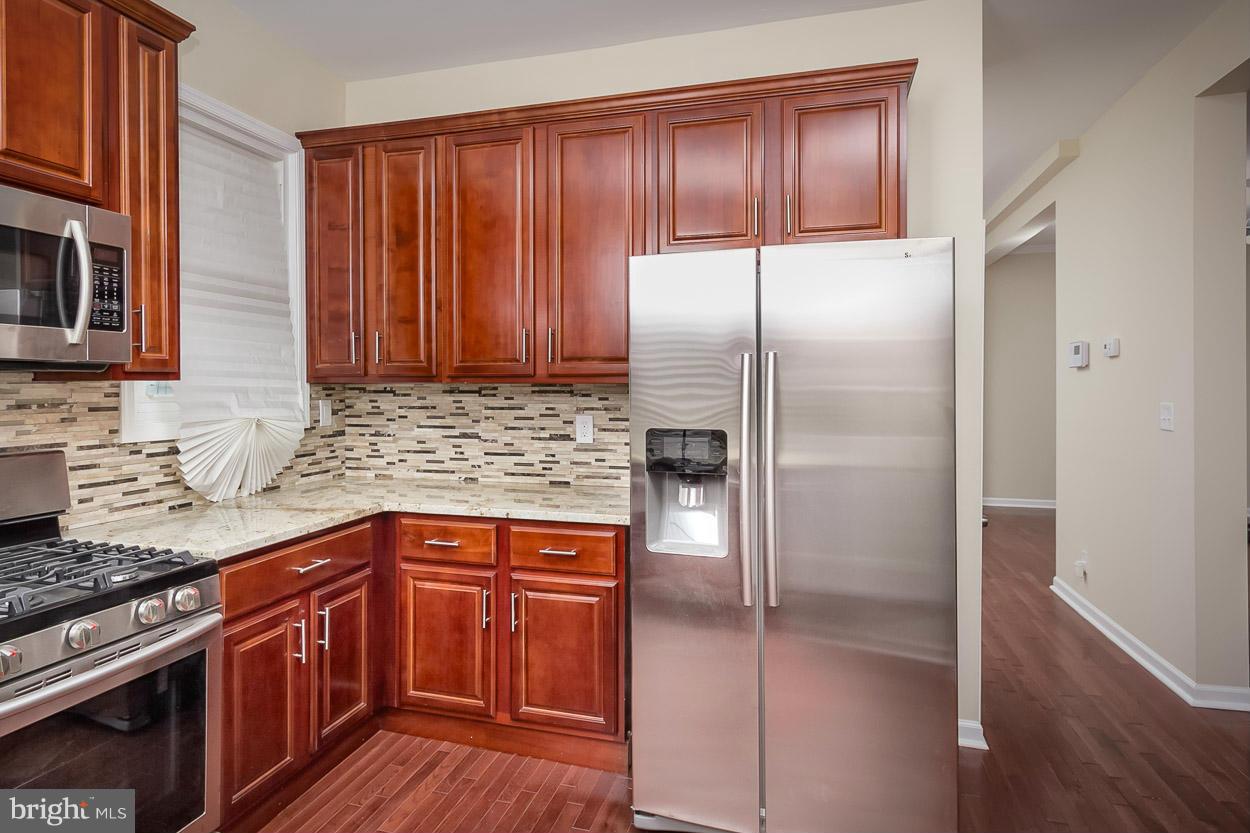 2903 Allendale Road Baltimore, MD 21216 - Photo 4 of 30 a kitchen with granite countertop a refrigerator and a sink