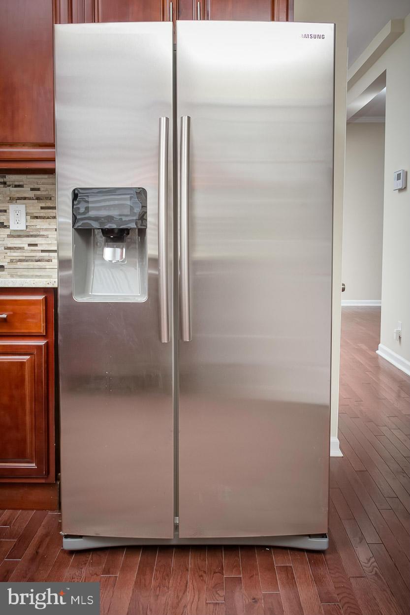 2903 Allendale Road Baltimore, MD 21216 - Photo 6 of 30 a close view of a refrigerator in kitchen and an empty room