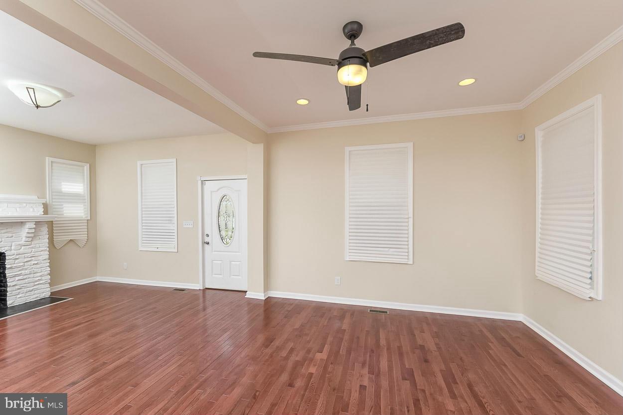 2903 Allendale Road Baltimore, MD 21216 - Photo 10 of 30 an empty room with wooden floor and windows