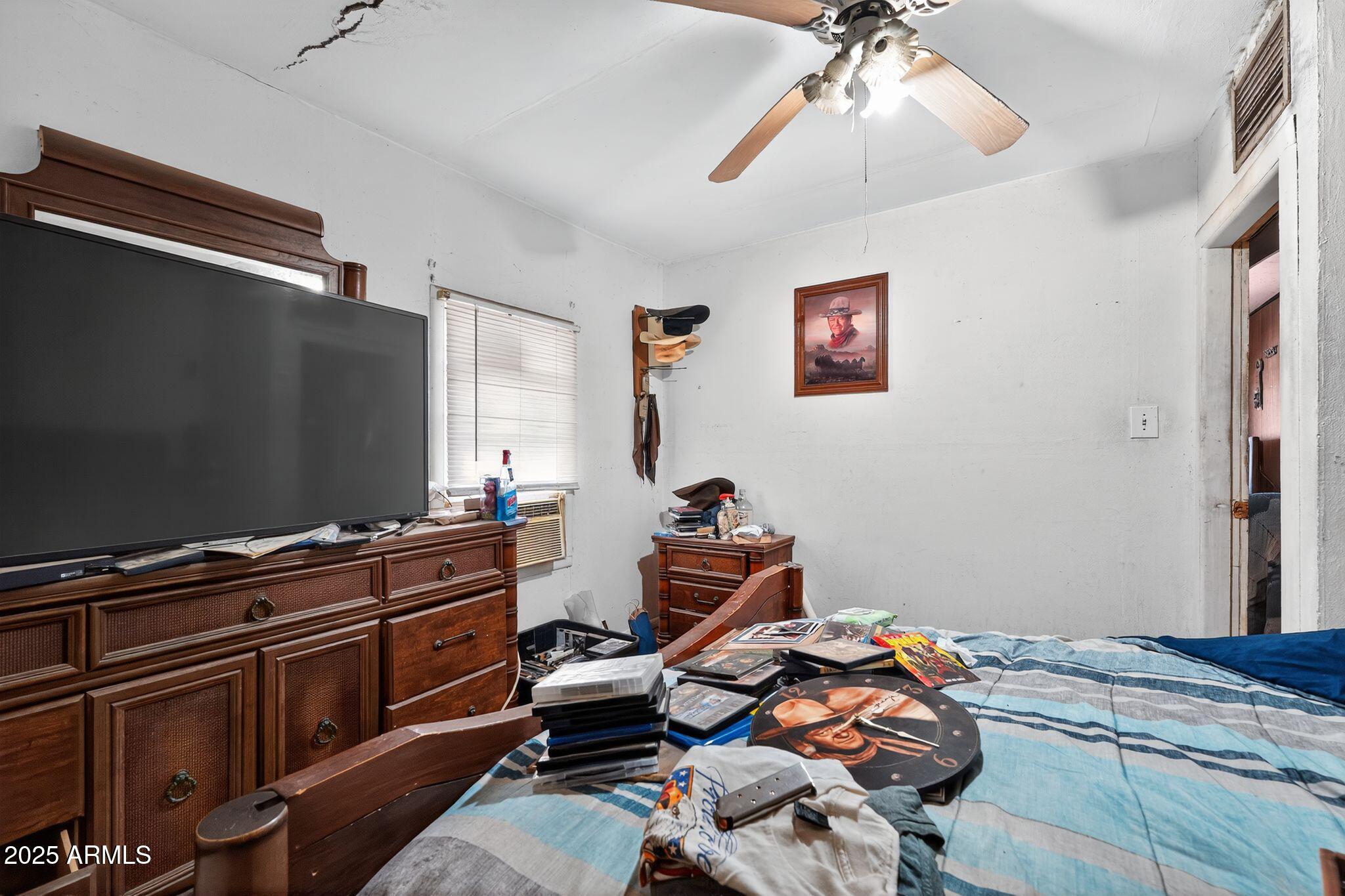 198 Randall Avenue Winkelman, AZ 85192 - Photo 12 of 30 a bedroom with a bed and wooden floor