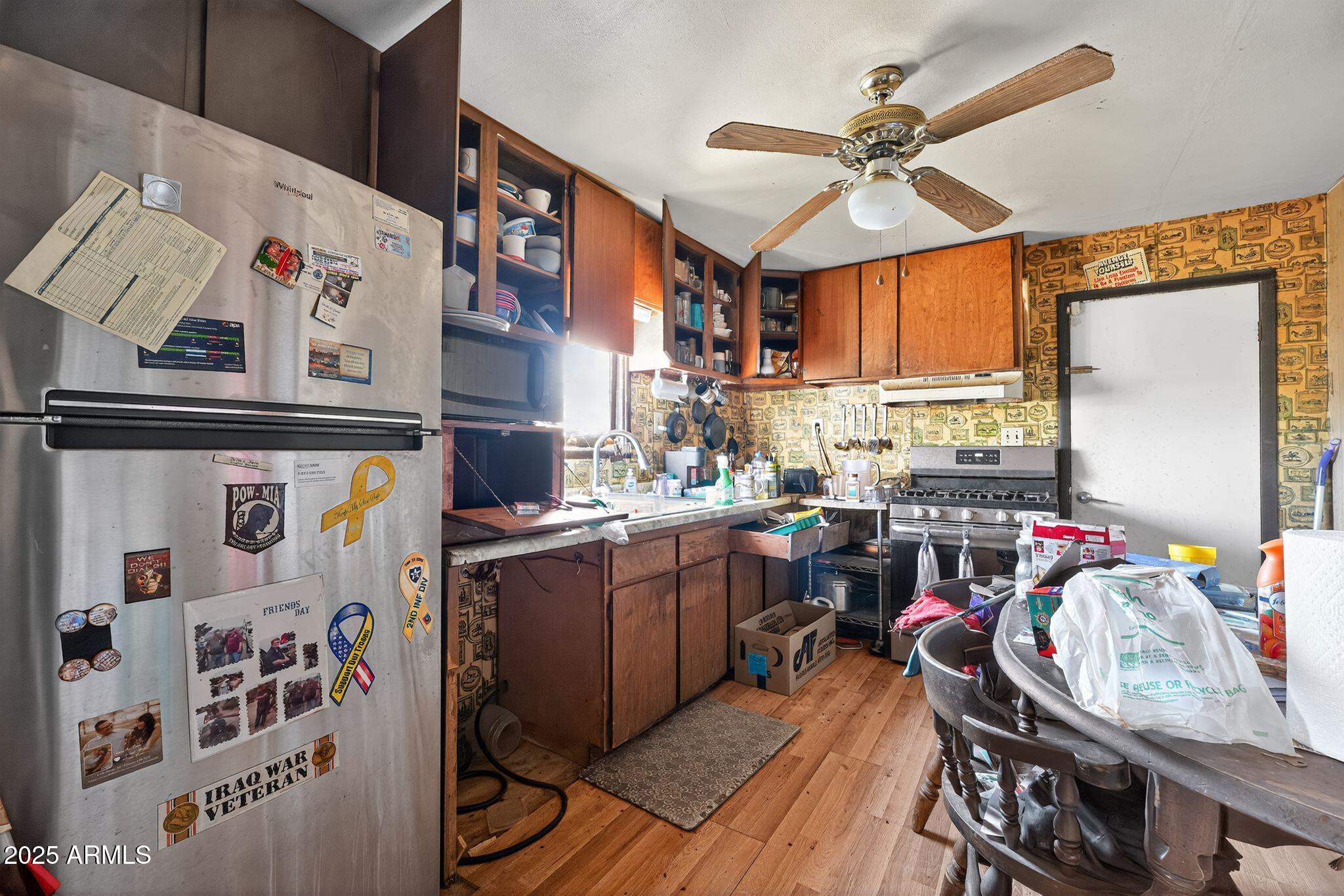 198 Randall Avenue Winkelman, AZ 85192 - Photo 10 of 30 a kitchen with stainless steel appliances granite countertop a sink stove and cabinets