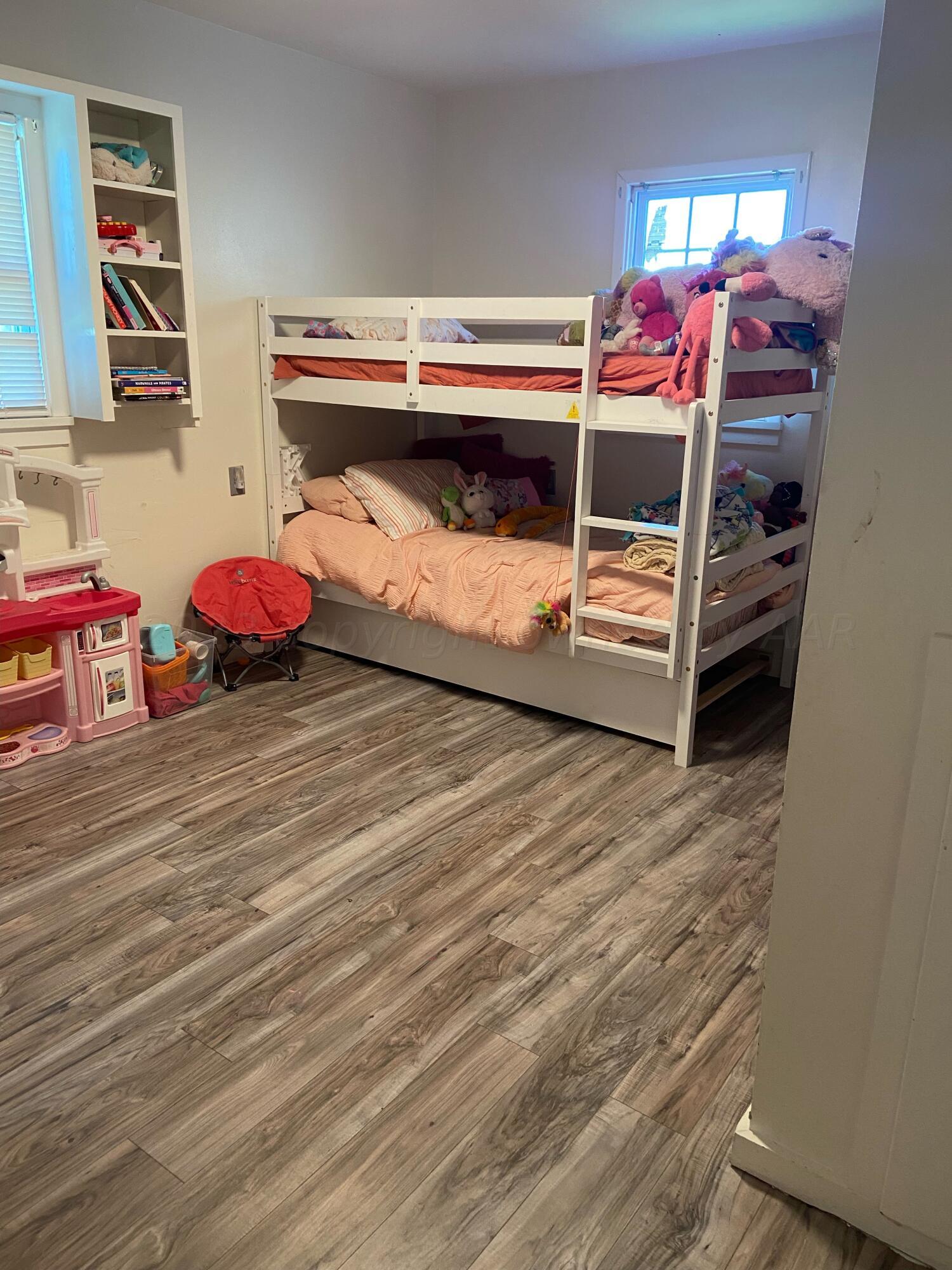 720 Santa Fe Avenue Channing, TX 79018 - Photo 11 of 23 a bedroom with a bunk bed and a dresser