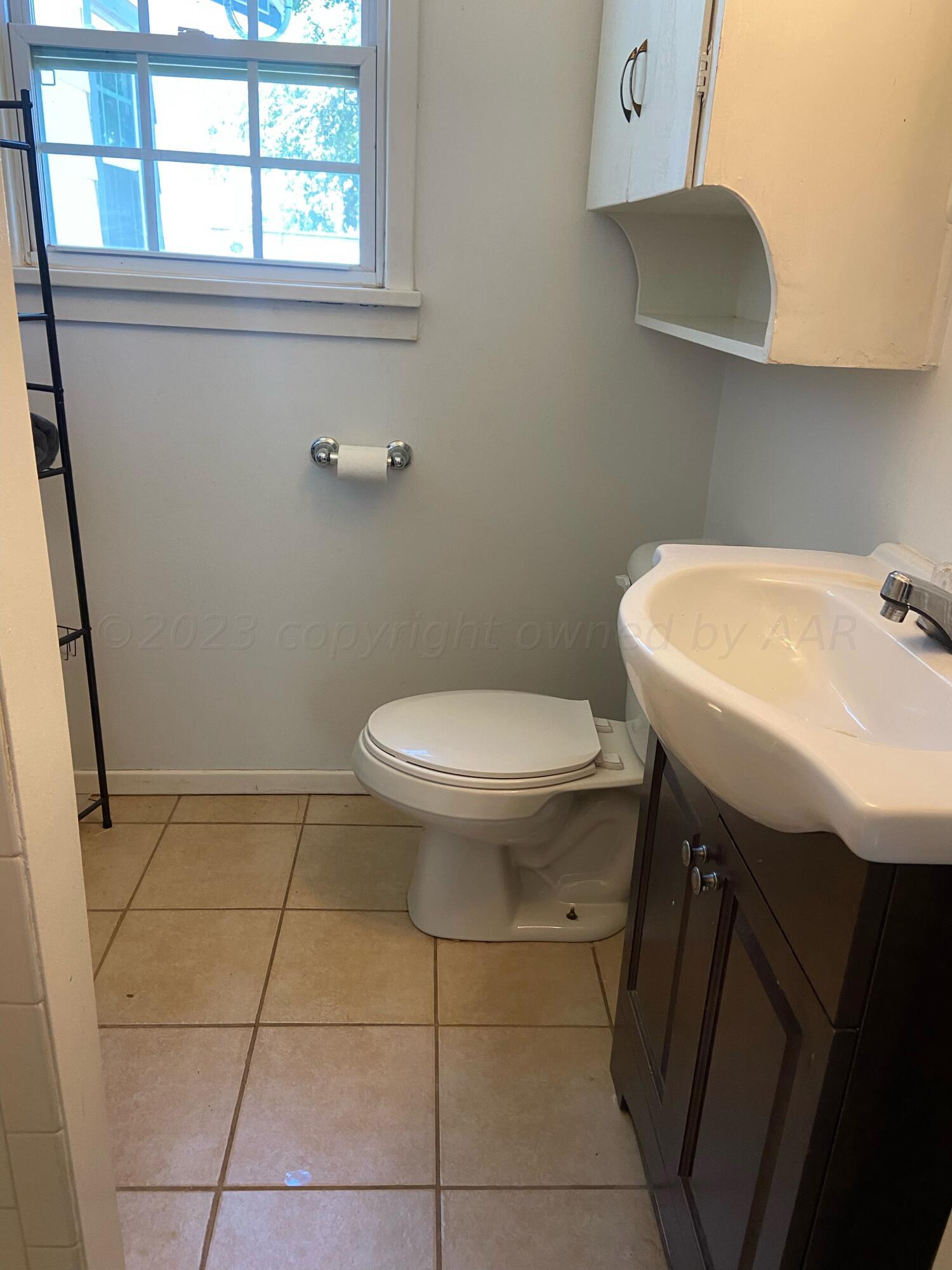 720 Santa Fe Avenue Channing, TX 79018 - Photo 16 of 23 a bathroom with a sink a toilet and a mirror