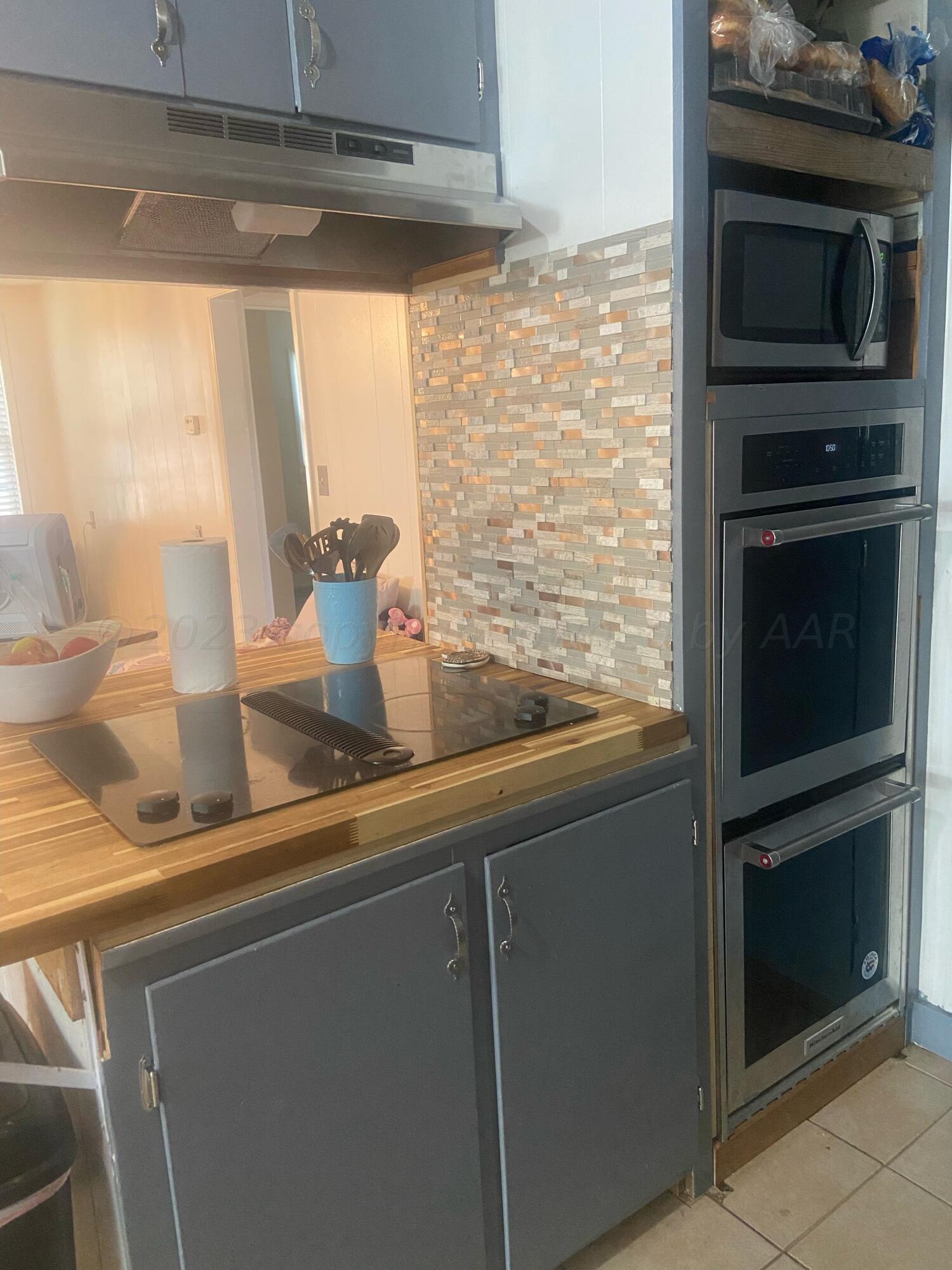 720 Santa Fe Avenue Channing, TX 79018 - Photo 5 of 23 a kitchen with a stove and a microwave