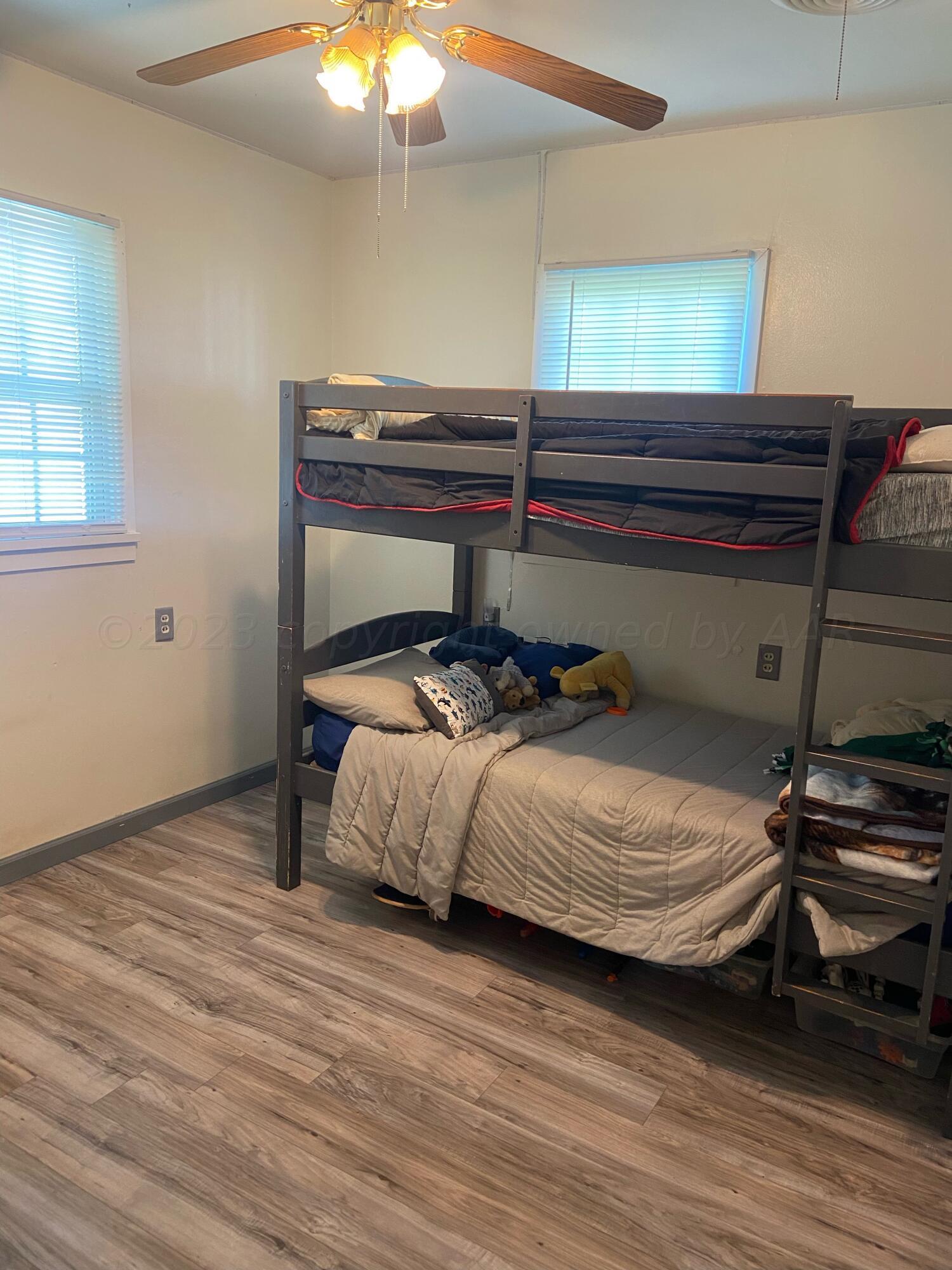 720 Santa Fe Avenue Channing, TX 79018 - Photo 9 of 23 a bedroom with a bed and a chandelier