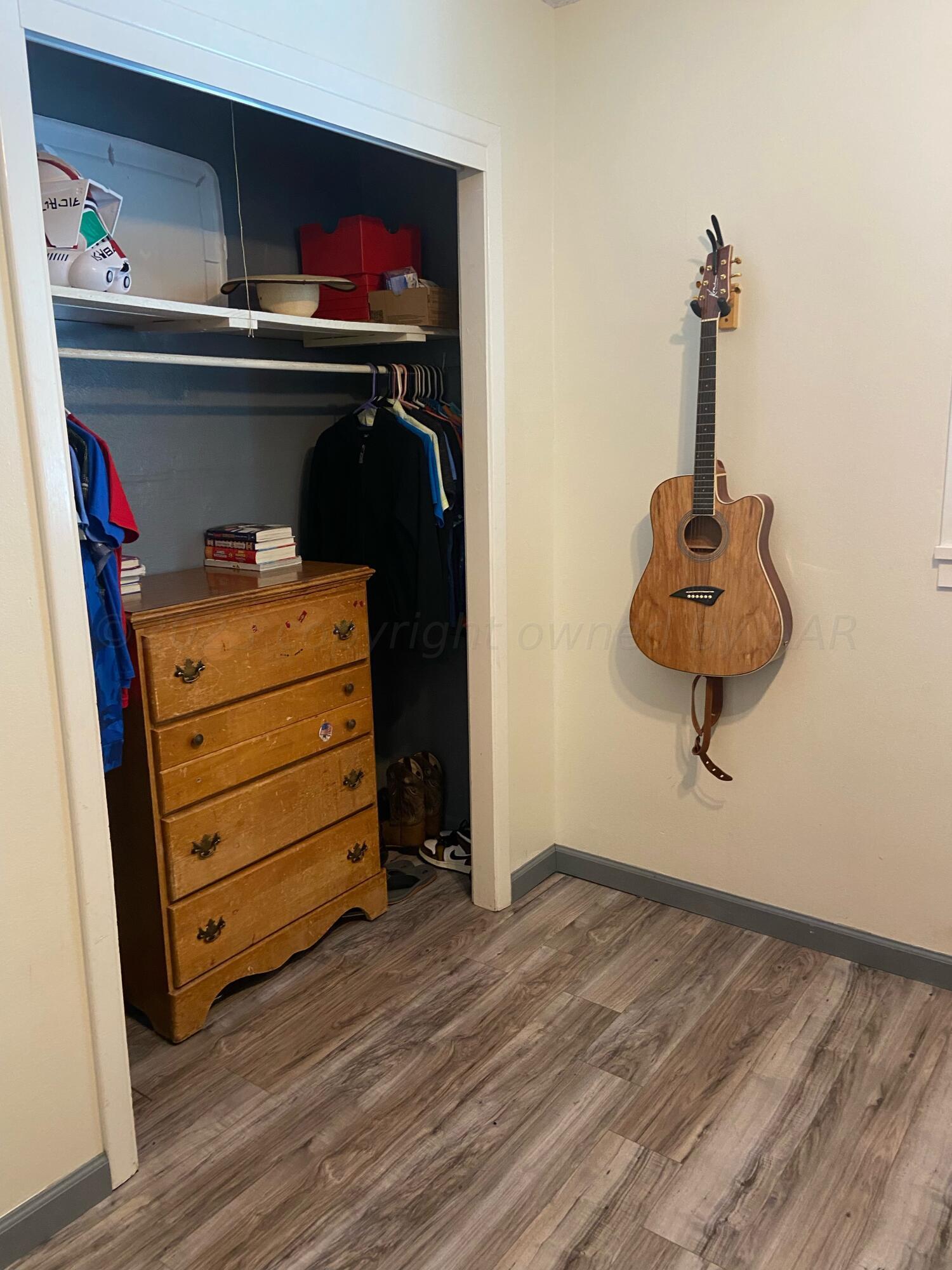 720 Santa Fe Avenue Channing, TX 79018 - Photo 10 of 23 a room with a walk in closet and a mirror