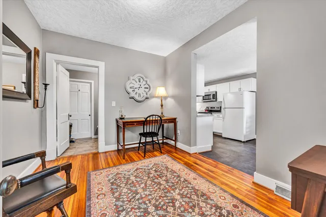 a kitchen with white cabinets and white appliances