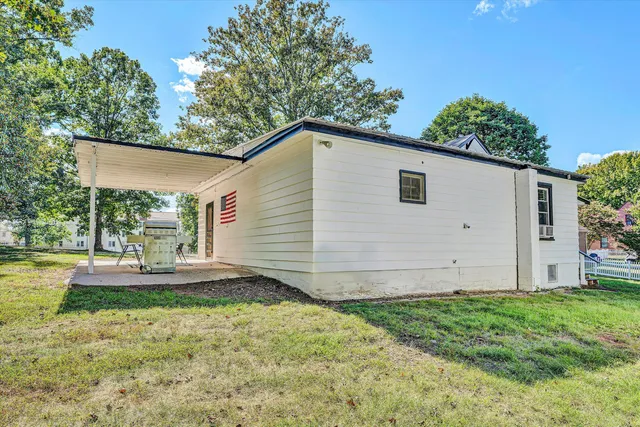 an aerial view of residential houses with outdoor space and trees