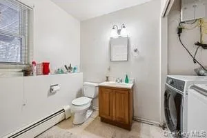 a bathroom with a granite countertop sink a toilet and a mirror
