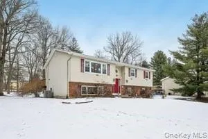 a front view of a house with a yard covered in snow