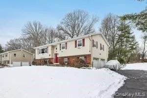 a view of a white house with a snow on the road