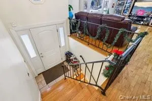 a living room with furniture a flat screen tv and a large window