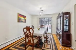 a kitchen with a table chairs microwave and cabinets