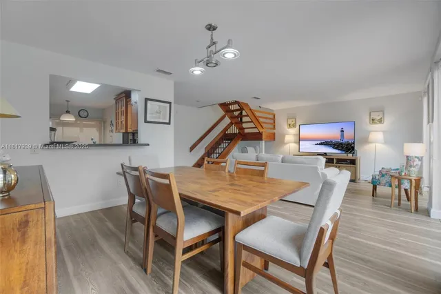 a dining room with furniture and wooden floor