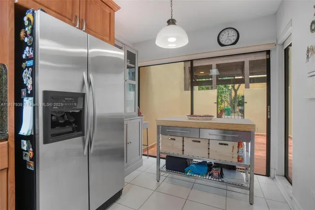 a kitchen with stainless steel appliances granite countertop a refrigerator and a stove top oven