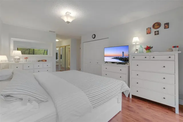 a bedroom with a bed and a flat screen tv