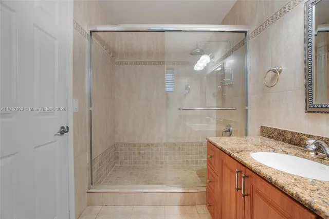 a bathroom with a sink vanity and a mirror